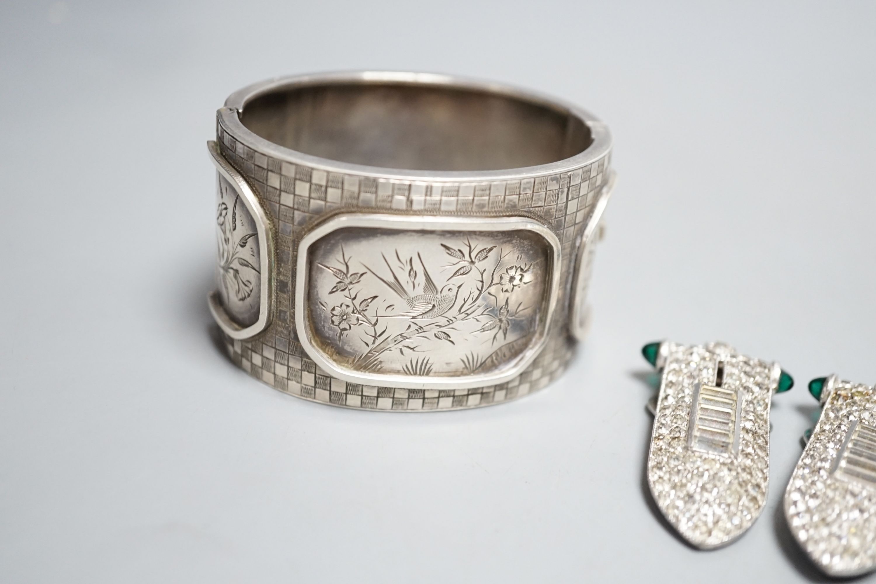 A pair of art deco paste clip earrings and a sterling bangle.